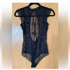 A stunning lace bodysuit. New!